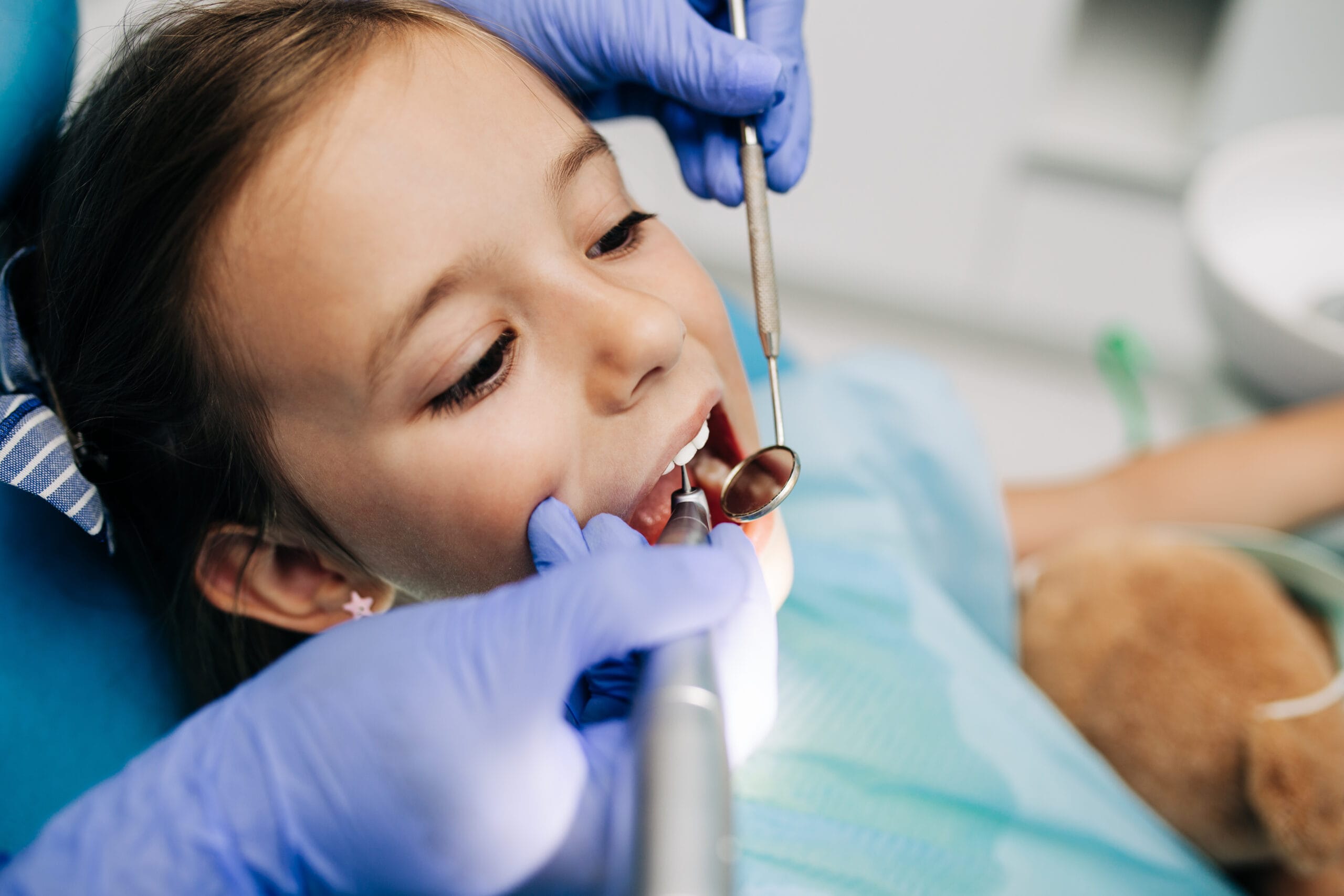 Cute little girl sitting on dental chair and having dental treat Children’s Dentistry Sarnia